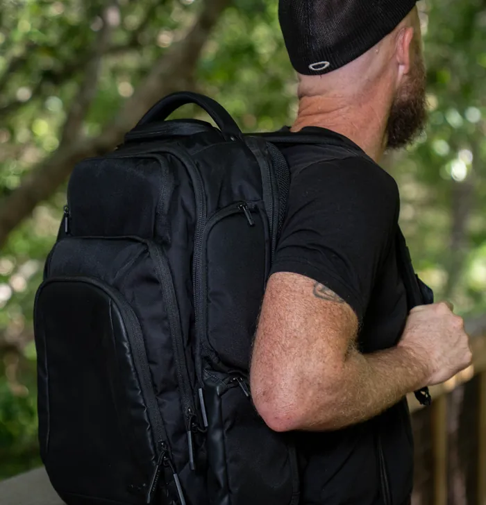 Man carrying the EscapeZone Dual backpack outdoors