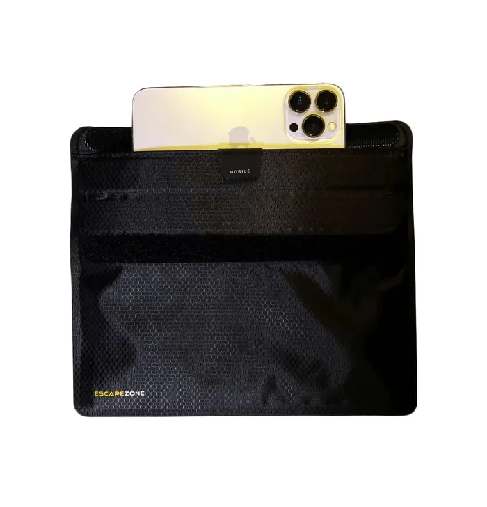 Phone sliding into the EscapeZone Faraday bag